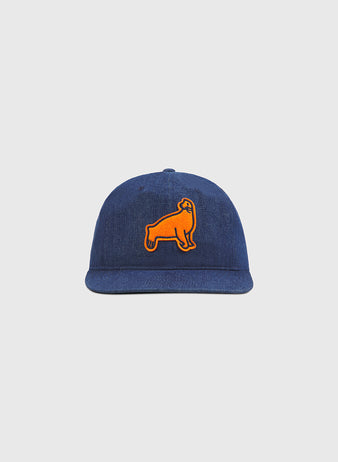 The Ebbets Field San Francisco Seals Indigo Cotton Denim Ballcap showcases a blue denim design with an orange patch of a standing dog on the front, evoking the classic style of historic Seals headwear and presented against a plain light gray background.