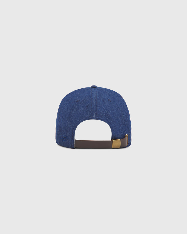 The Ebbets Field San Francisco Seals Indigo Cotton Denim Ballcap is shown from the back, featuring an adjustable brown strap with a gold buckle, set against a plain light gray background.