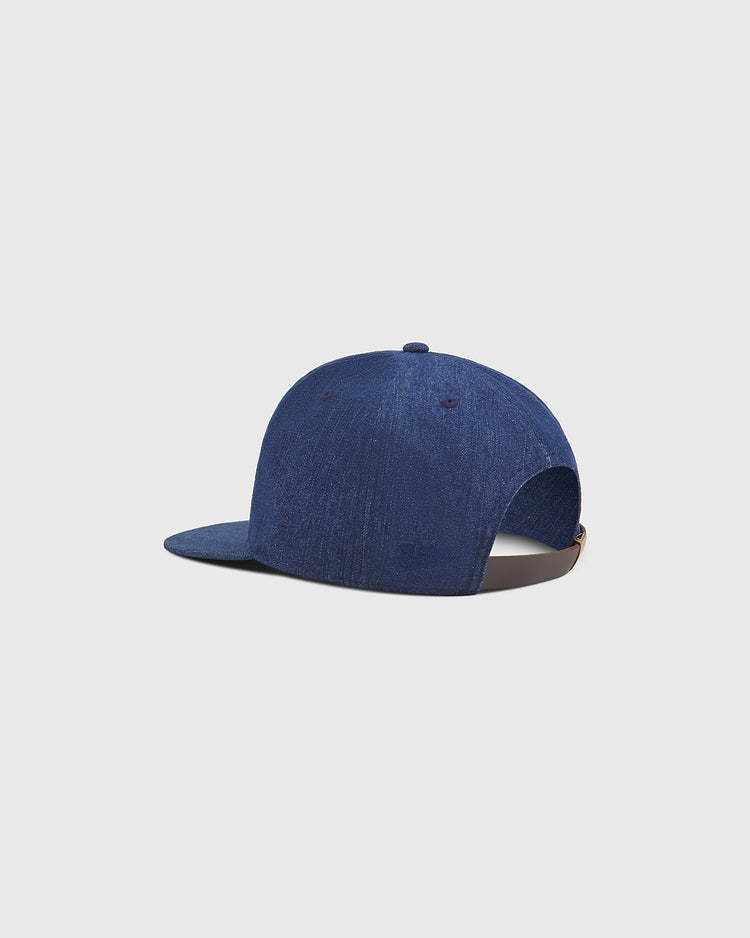 An Ebbets Field San Francisco Seals Indigo Cotton Denim Ballcap is displayed backwards on a plain light gray background, highlighting the back opening and adjustable strap.
