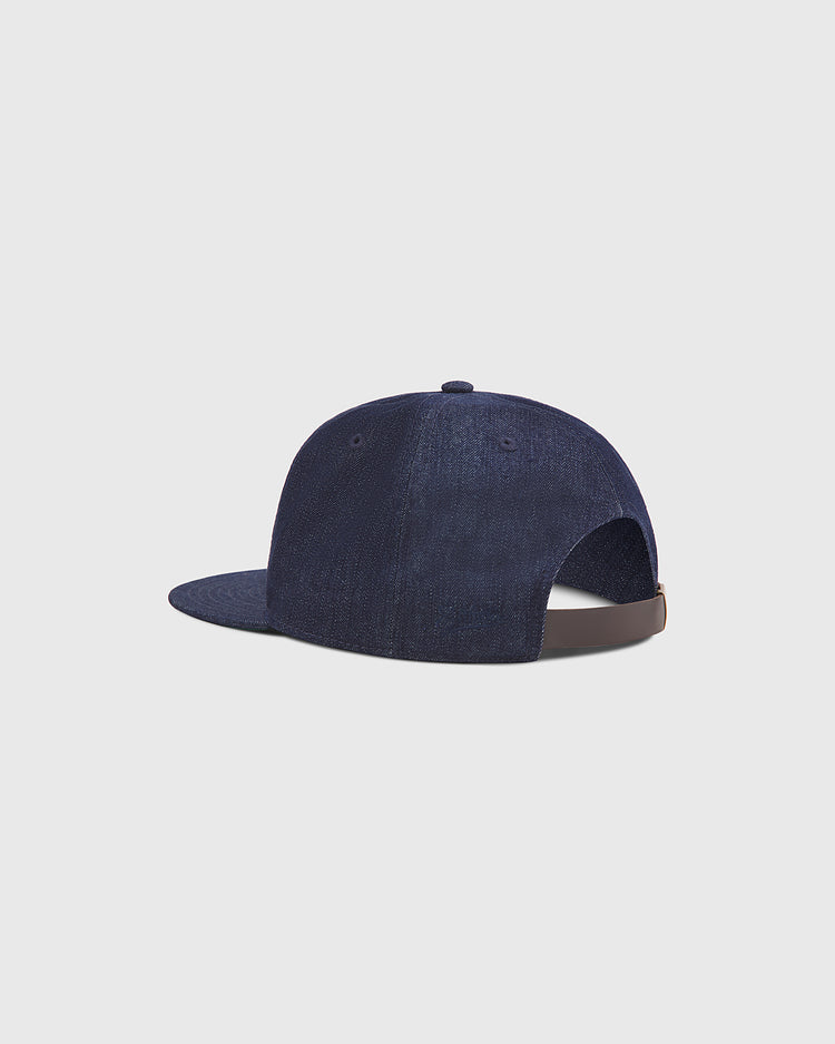 The Kansas City Monarchs Indigo Cotton Denim Ballcap by Ebbets Field is displayed from the back, highlighting its adjustable strap and flat brim, set against a plain light background.