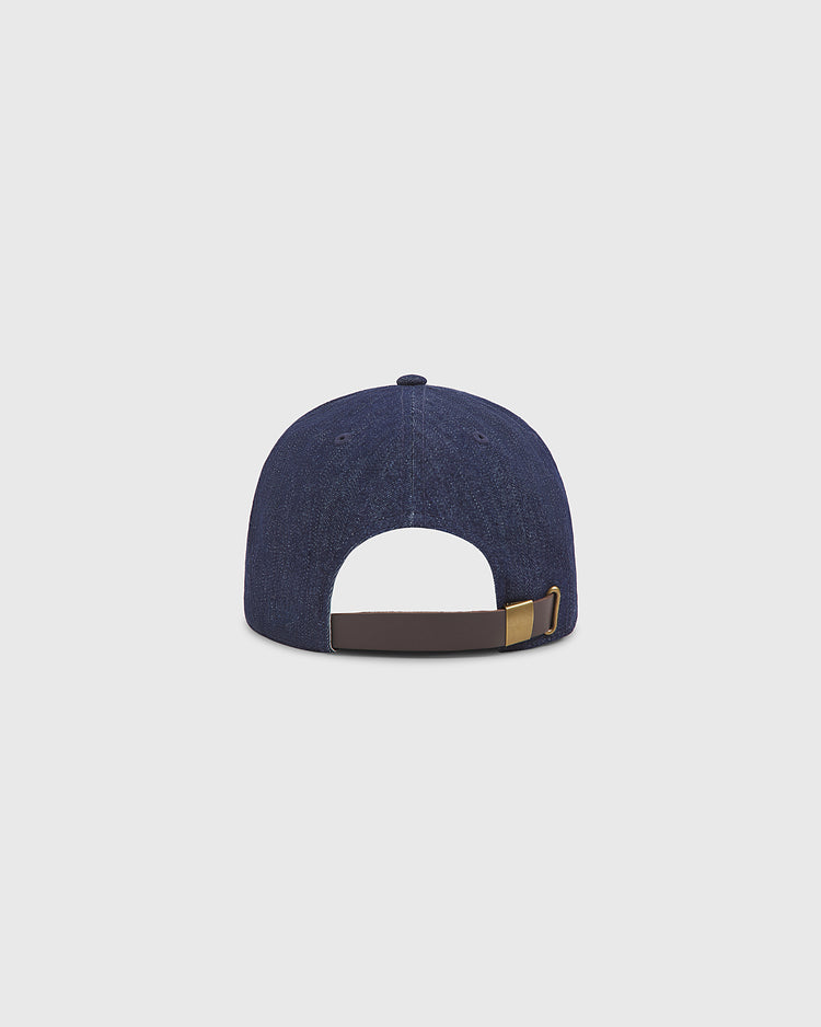 An Ebbets Field New York Black Yankees Indigo Cotton Denim Ballcap is displayed from the back, highlighting its brown adjustable strap with a metallic buckle, set against a plain light gray background.