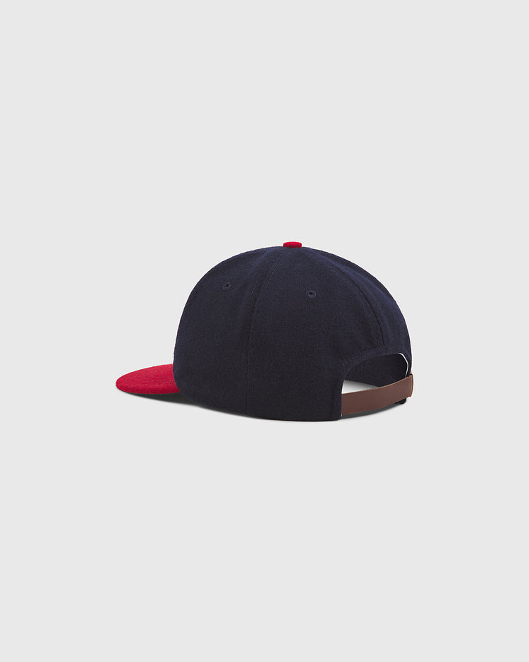 A Philadelphia Stars 1940 Authentic Wool Ballcap by Ebbets Field is displayed from the back. The navy blue cap features a red brim, brown adjustable strap, and a small red button on top. The background is light gray.