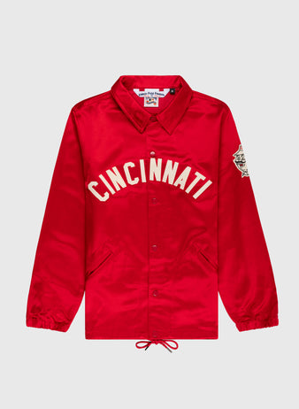 The EFF Cincinnati Reds 1955 Satin Windbreaker Jacket features bright red satin, bold white “CINCINNATI” lettering, a left sleeve patch, button front, drawstring hem, side pockets, and pointed collar—vintage MLB style.