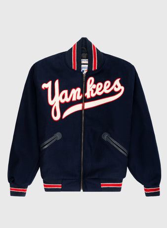 The EFF New York Yankees 1947 Authentic All Wool Varsity Jacket in navy features bold white and red Yankees script, striped trim, two slanted pockets—a classic tribute to the 1947 World Champions.