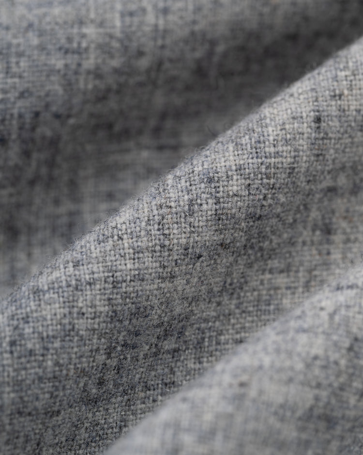 A close-up of light gray, textured fabric with visible weave and soft folds, evoking the vintage Ebbets Field Birmingham Black Barons 1948 Authentic Wool Road Baseball Jersey seen at the Negro Leagues Baseball Museum.