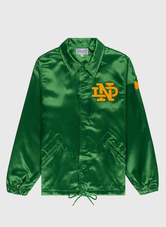 The EFF University of Notre Dame Satin Windbreaker Jacket is a shiny green satin jacket with a collar, yellow ND chest logo, yellow sleeve patch, front pockets, button closure, elastic cuffs, and drawstring hem.