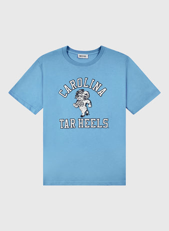 The Ebbets Field University of North Carolina Short Sleeve Tee is light blue with Carolina Tar Heels text and a cartoon ram mascot in white and black on the front.