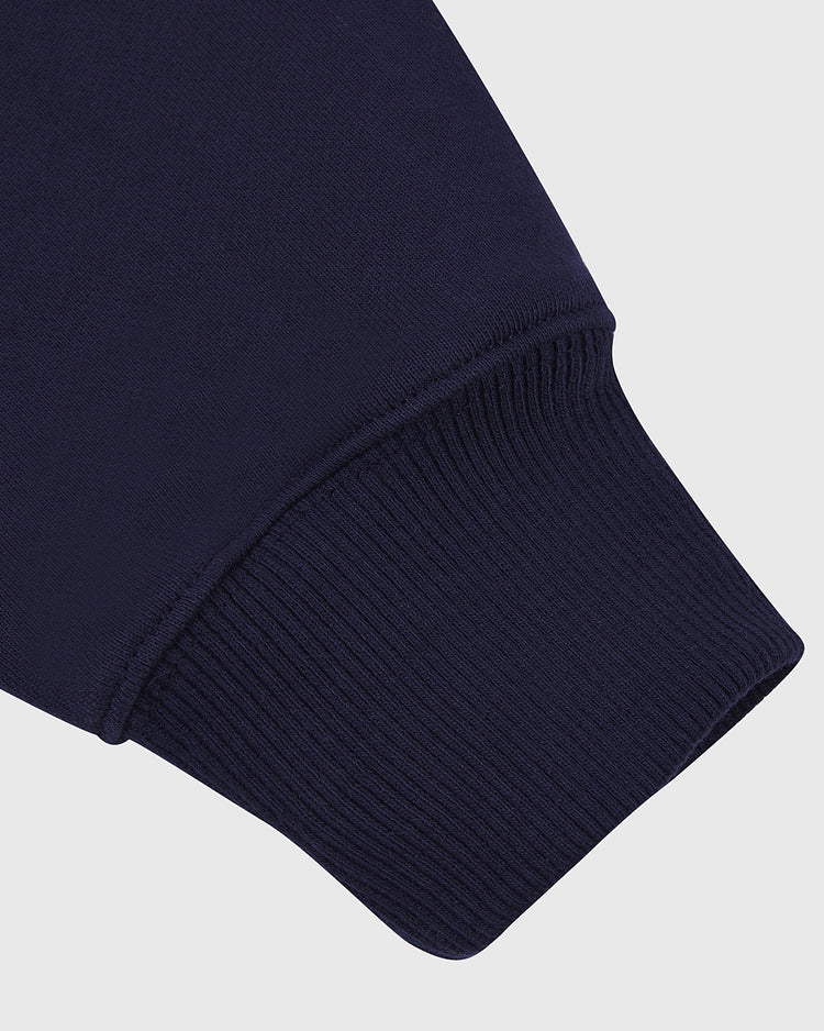 Close-up of the ribbed, stretchy cuff on the Ebbets Field PENN STATE HOODIE NAVY sleeve, set against a plain light background.