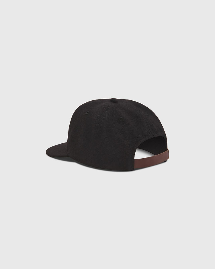 A black The Clemente Museum X Ebbets Field Wool Ballcap by Ebbets Field is shown from the back, highlighting its brown adjustable strap. The classic wool design makes it a standout addition to any Clemente collection. The background is a plain light gray.