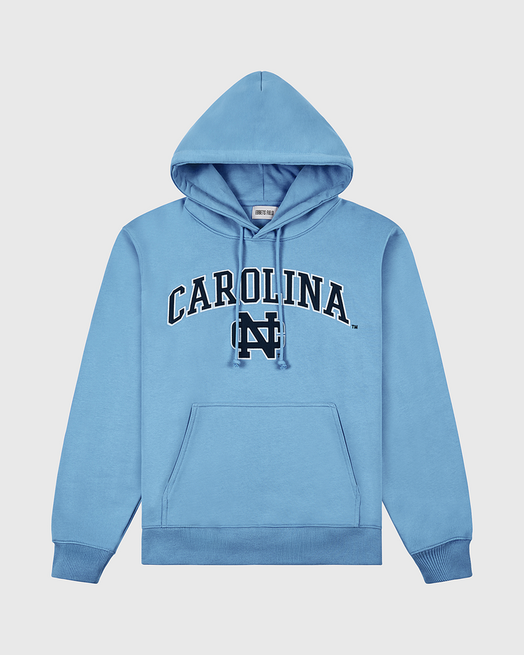 The University of North Carolina Heavyweight Cotton Terry Pullover Hoodie by Ebbets Field features “CAROLINA” in bold black letters and an interlocking “NC” logo, front pocket, and ribbed cuffs—perfect for showing Tar Heels pride. Laid flat on white background.
