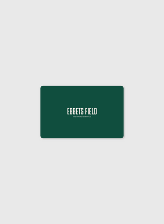 A green rectangular E-Gift Card from Ebbets Field with rounded corners displays “EBBETS FIELD” in white and “THE VINTAGE APPAREL CO.” below, centered on a light gray background—ideal for easy, stylish email gifting.