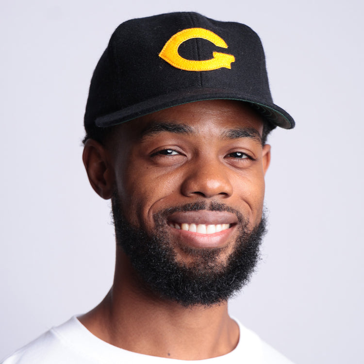 A bearded man in a white tee wears an EFF Grambling State University 1963 Vintage Ballcap, standing against a light background and proudly showing off his HBCU apparel.