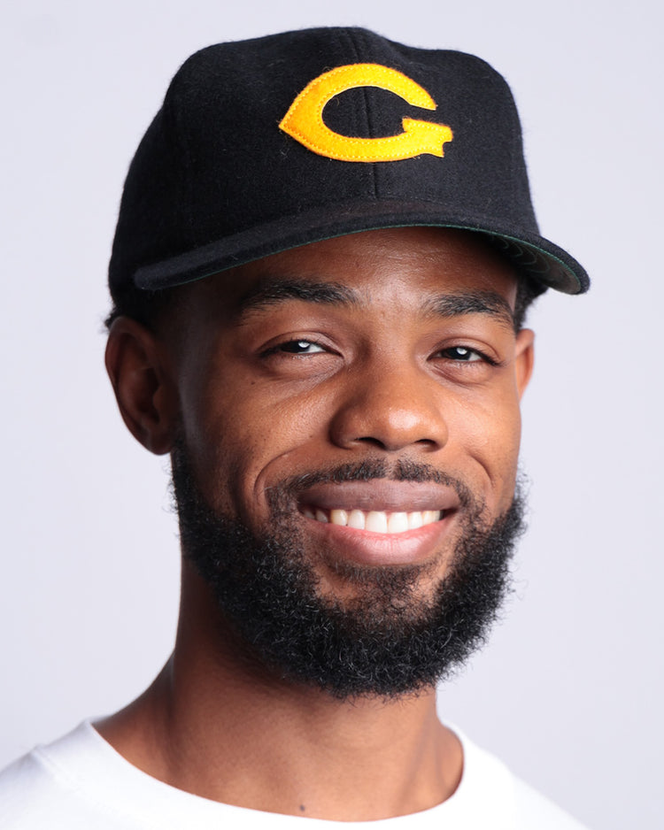 A bearded man in a white tee wears an EFF Grambling State University 1963 Vintage Ballcap, standing against a light background and proudly showing off his HBCU apparel.