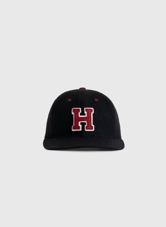 The EFF Harvard University Crimson H Authentic Wool Ballcap, a black cap with a bold red H and white outline on the front, is shown against a plain light gray background.