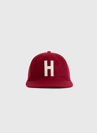 The EFF Harvard University 1950 Authentic Wool Ballcap, featuring a red design with a white H on the front, is an authentic reproduction shown against a plain light gray background.