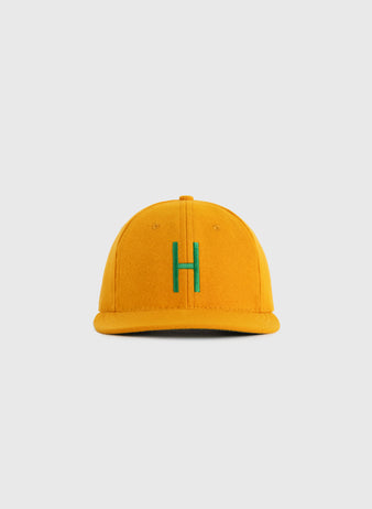 The EFF Hawaii Islanders 1961 Authentic Wool Ballcap is a yellow cap with a green H on the front, inspired by the original teams design, displayed against a plain light gray background.
