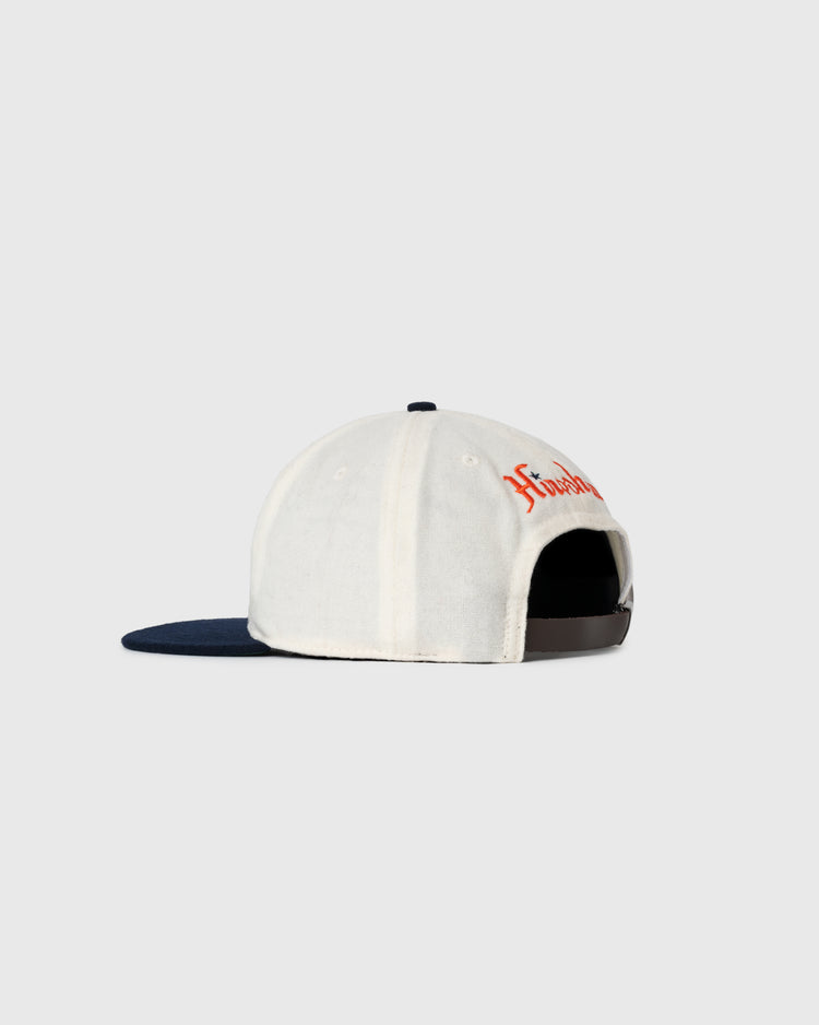 The EFF Hiroshima Carp Off White Wool Ballcap is shown from the back, featuring a dark blue brim, visible adjustable strap, and partial red text on the front right side. The background is light gray.