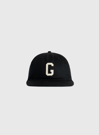 The Ebbets Field Flannels Homestead Grays Felt G Cotton Twill Ballcap features a black cotton twill build with a white felt G on the front, inspired by the classic Homestead Grays cap, shown on a plain light gray background.