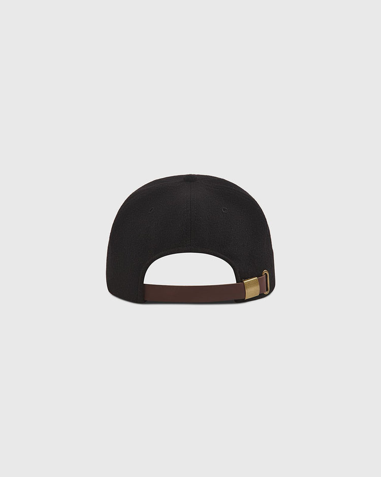A rear view of The Clemente Museum X Ebbets Field Wool Ballcap by Ebbets Field, featuring a brown adjustable strap with a gold-colored buckle, set against a plain light gray background. Part of the Clemente Collection, this classic wool ballcap honors baseball heritage and the legacy celebrated by the Roberto Clemente Museum.