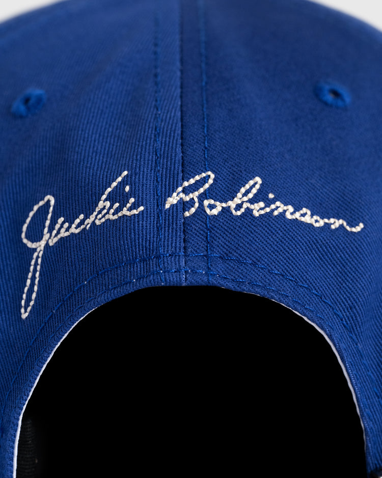 Close-up of the back of the Ebbets Field Jackie Robinson Day Montreal Royals ‘M’ Cotton Twill Ballcap, featuring white embroidered Jackie Robinson text.