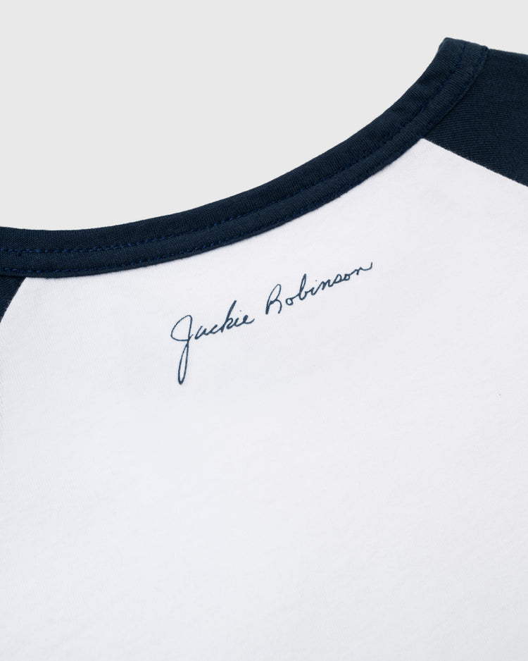 Close-up of the Jackie Robinson 42 Vintage Baseball Tee by Ebbets Field, featuring navy blue trim and Jackie Robinson in cursive near the neckline—an iconic tribute to a baseball legend.