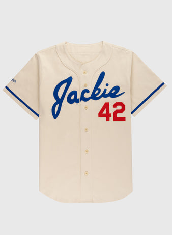 The Ebbets Field Jackie Robinson Cotton Twill Baseball Jersey features a cream color, blue trim, “Jackie” in blue script on the front, and red 42 on the right—an iconic tribute to baseball legend Jackie Robinson.