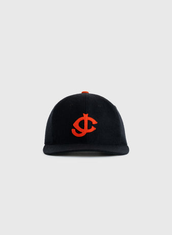 The EFF Jersey City Giants 1950 Authentic Wool Ballcap is black with an orange embroidered interlocking J and C logo, inspired by the historic team, and shown against a plain light gray background.