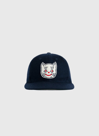 The EFF Kansas City Katz 1961 Authentic Wool Ballcap in navy features an embroidered white cat face with red eyes and a red smile on the front, shown against a plain light gray background.