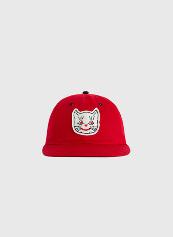 The EFF Kansas City Katz Cotton Twill Ballcap is a red hat with an embroidered white cat face, blue eyes, and a pink nose on the front, shown against a plain light gray background.
