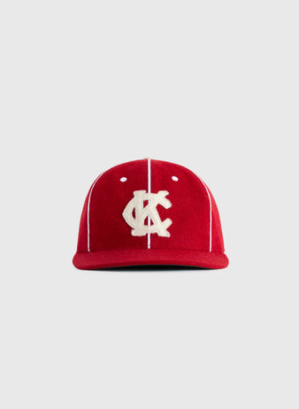 The EFF Kansas City Monarchs 1949 Authentic Wool Ballcap features red wool, white vertical piping, and a bold KC logo, inspired by the iconic 1949 team, shown here on a plain light gray background.