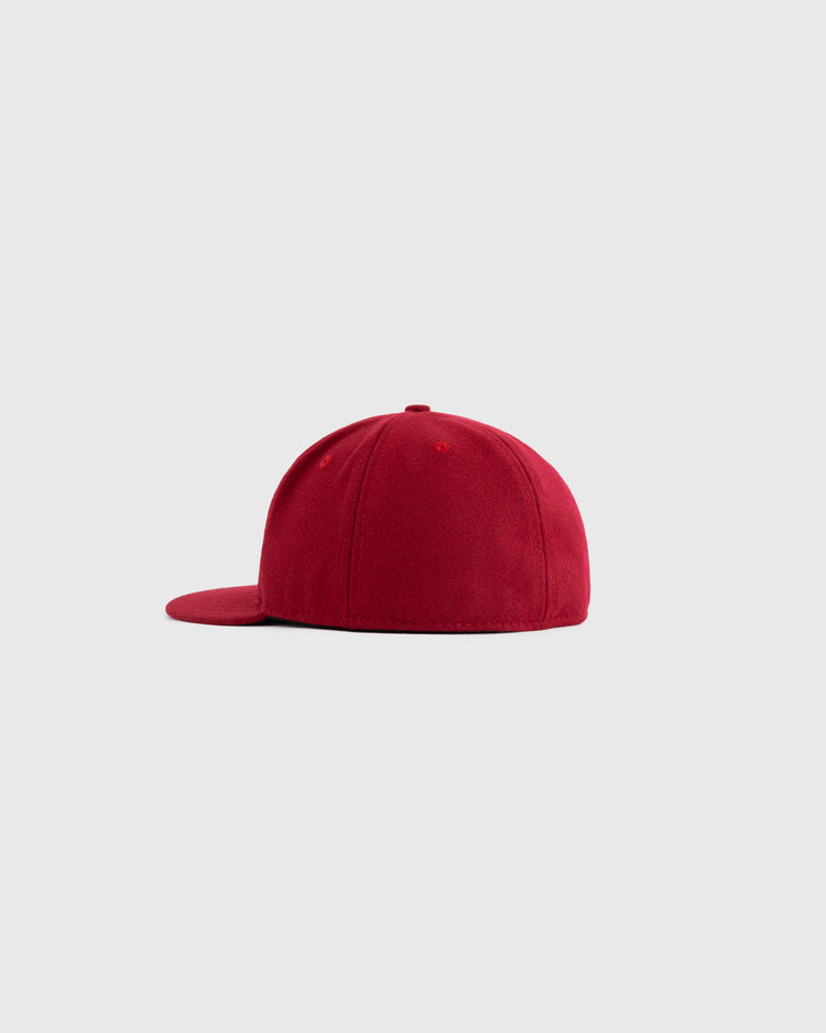 The EFF Kansas City Monarchs 1936 Authentic Wool Ballcap, shown in side view with a flat brim on a light gray background, features a classic red design inspired by the iconic teams style.