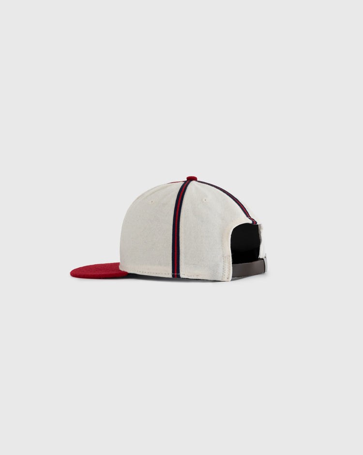 The EFF Kansas City Monarchs 1942 Authentic Wool Ballcap features a cream color, red brim, blue and red stripes front to back, and an adjustable strap. Shown from the back and side, it echoes the classic 1942 design.