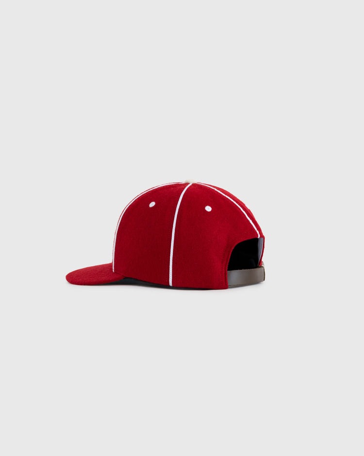 The EFF Hollywood Stars 1940 Authentic Wool Ballcap is a red cap with white piping, flat brim, and adjustable black strap, inspired by the original Pacific Coast League design. Set against a light gray background.