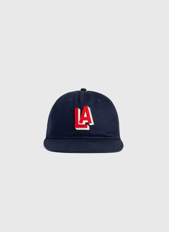 The Ebbets Field Los Angeles Angels (PCL) 1942 Logo Cotton Twill Ballcap in navy blue features a red and white LA logo embroidered on the front, capturing the authentic style of classic PCL baseball hats.