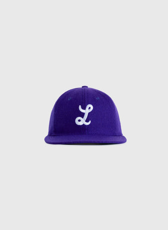 The EFF Louisiana State University 1957 Authentic Wool Ballcap is a vintage purple baseball cap with a white embroidered L on the front, faithfully reproducing the classic 1957 LSU design.
