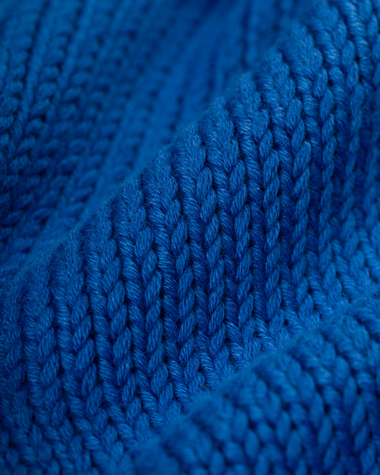 Close-up of textured blue knit and detailed stitches on the Ebbets Field Flannels Seattle Mariners 1977-80 Wool Shawl Collar Sweater.