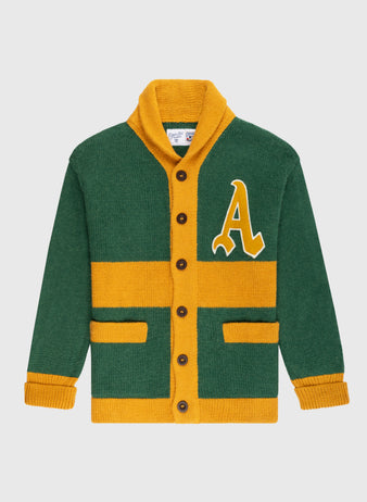 The Ebbets Field Flannels Oakland Athletics 1969 Wool Shawl Collar Sweater features green and yellow colors, brown buttons, two front pockets, yellow stripes, and a large yellow A patch on the left chest, shown on a white background.