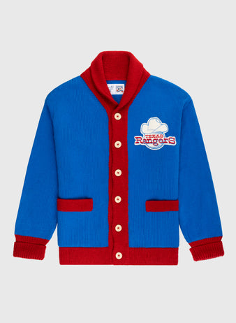 The Ebbets Field Flannels Texas Rangers 1972 Wool Shawl Collar Sweater is a blue knit replica with red trim, buttons, and pockets, plus a Rangers logo patch on the chest—a stylish choice for true MLB fans.