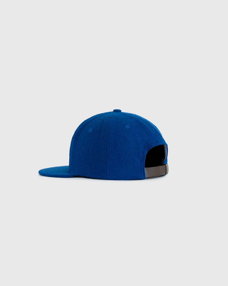 The EFF Green Bay Dodgers 1960 Authentic Wool Ballcap in blue is shown from the back with a black adjustable strap and flat brim, inspired by the original design, set against a plain light gray background.