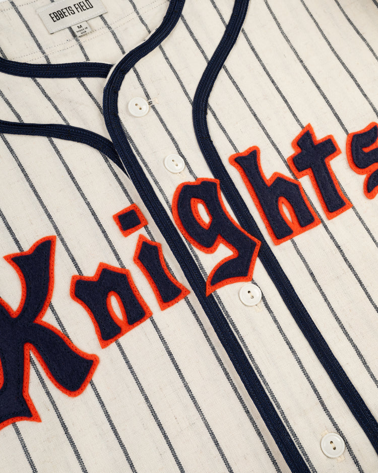 A close-up of the New York Knights 1939 Authentic Wool Home Baseball Jersey by Ebbets Field, featuring vintage-style white wool with blue pinstripes, navy trim, and red-outlined Knights lettering like in The Natural.