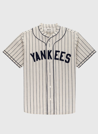 The Ebbets Field New York Black Yankees 1935 Authentic Wool Home Baseball Jersey features short sleeves, a button-up front, classic vertical navy pinstripes on white, and YANKEES across the chest in bold navy letters.