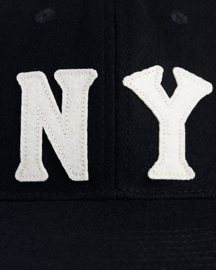 A close-up of the EFF New York Black Yankees 1936 Authentic Wool Ballcap, featuring large white embroidered N and Y letters on the front—a tribute to Negro Leagues history.