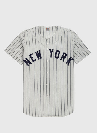 The Ebbets Field New York Black Yankees 1942 Authentic Wool Home Baseball Jersey features gray wool flannel with thin navy stripes, bold NEW YORK on the chest, white front buttons, and short sleeves inspired by the original Negro Leagues jersey.