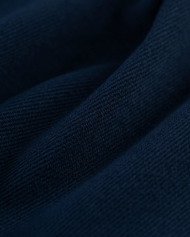 Close-up of Ebbets Field’s New York Black Yankees Cotton Twill Baseball Jersey in dark blue, showing its soft, textured cotton twill surface and diagonal folds that echo classic Negro Leagues style.