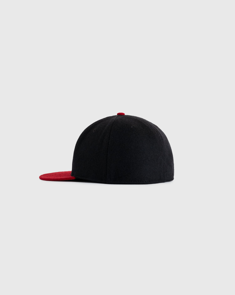 The EFF New York Cubans 1947 Authentic Wool Ballcap features a black design with a flat red brim and small red button, inspired by the historic ballcap, displayed in profile on a plain light gray background.