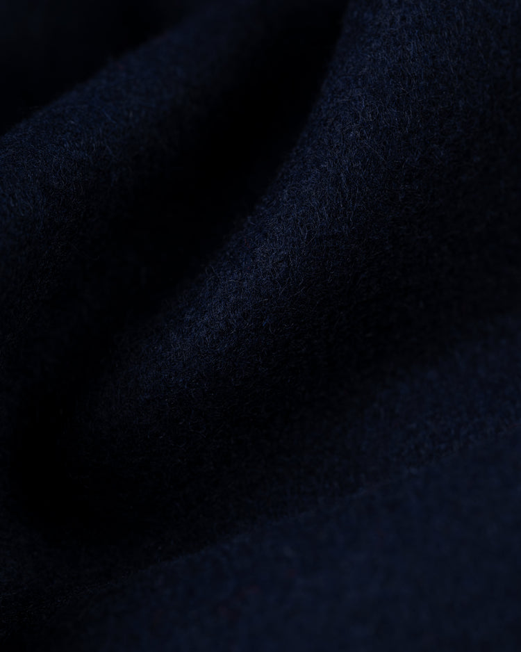 A close-up of the EFF New York Yankees 1947 Authentic All Wool Varsity Jacket shows dark navy fabric with a soft, fuzzy texture and gentle folds, evoking the legendary jackets worn by Yankees greats.