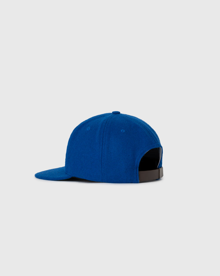 The Ebbets Field NEW - Pacific Greyhound 1939 Vintage Ballcap is a royal blue cap with a slightly curved brim, shown from the back and side, featuring a black adjustable strap against a plain light grey background.