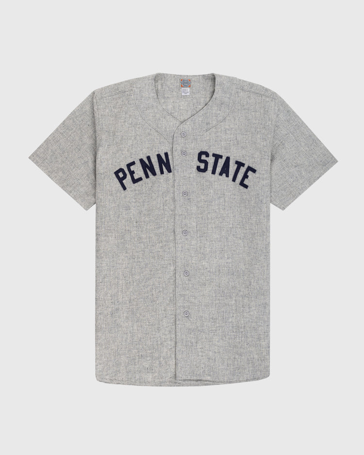 The Ebbets Field Penn State University 1955 Authentic Wool Road Baseball Jersey is a gray short-sleeve button-up featuring PENN STATE in large navy letters, inspired by the 1955 Nittany Lions, shown on a plain white background.