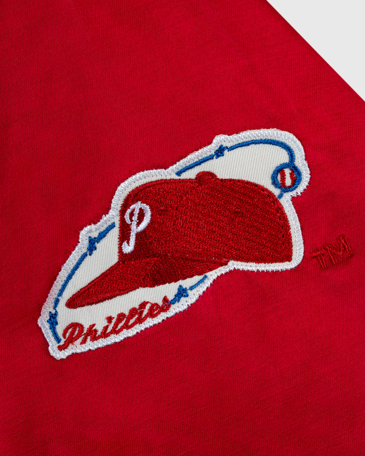 Close-up of an embroidered patch with a red cap and white P on the EFF Philadelphia Phillies 1950 Satin Windbreaker Jacket—ideal for fans of MLB vintage windbreakers.