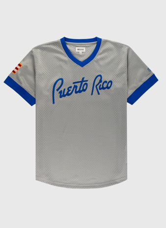 The Ebbets Field Puerto Rico 1958 National Team Mesh V-Neck Jersey features gray mesh, blue trim, Puerto Rico in blue script across the chest, and a red-and-white striped sleeve patch—a classic Puerto Rican baseball jersey.